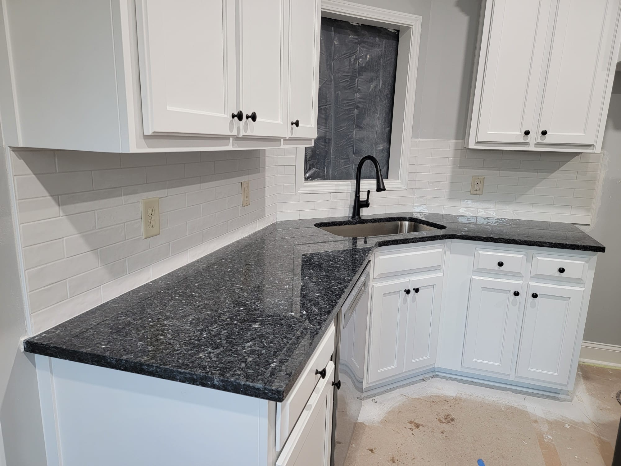 Finished Atlanta kitchen with white cabinets and granite counters